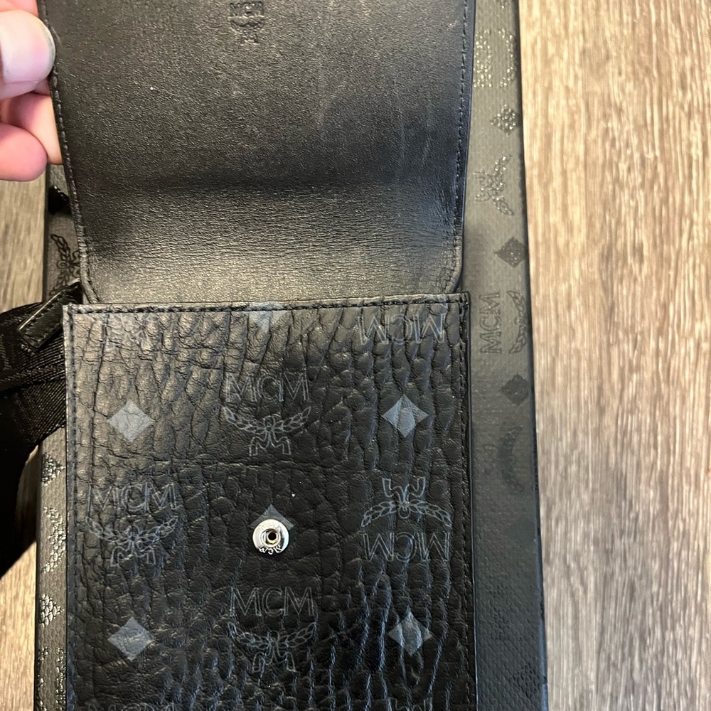 MCM Visetos crossbody bag that can fit phone along with other items.